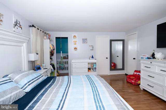 a bedroom with furniture and a wooden floor