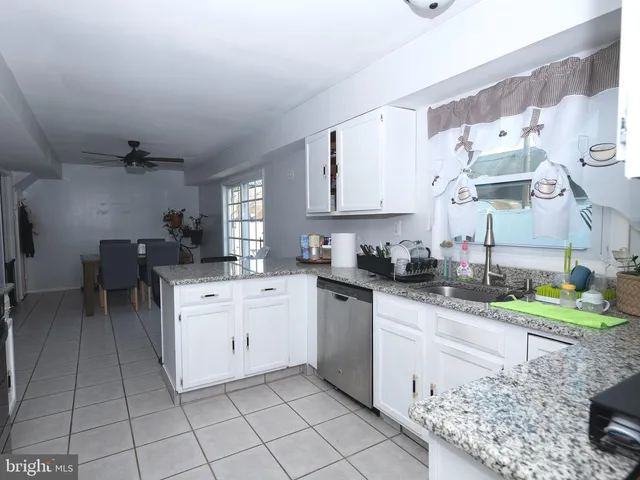 a kitchen with stainless steel appliances granite countertop a sink and a cabinets