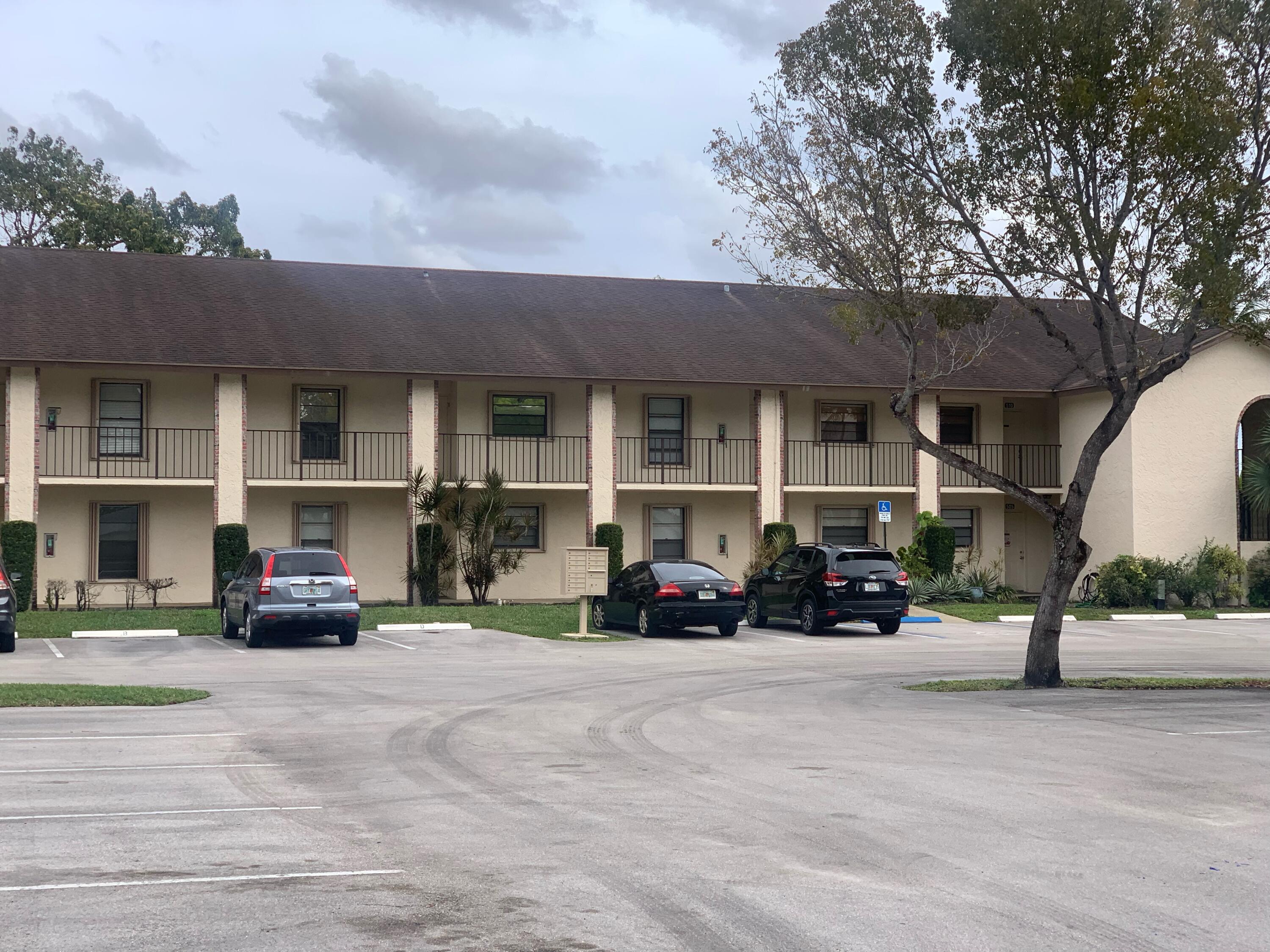 23466 Lyons Road, Unit 509 Boca Raton, FL 33428 - Photo 4 of 17 a car parked in front of a building