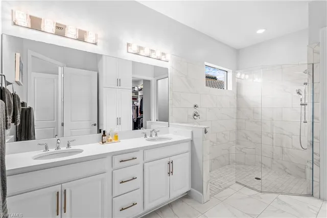 a bathroom with double sink and a mirror