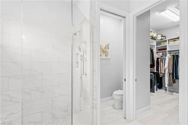 a bathroom with a shower and a toilet