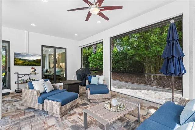 a living room with furniture a large window and a table