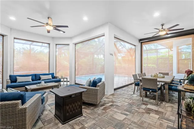 a living room with furniture and large windows