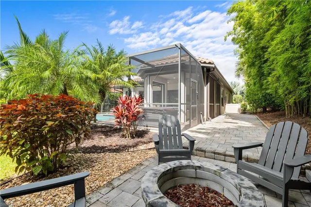a view of a backyard with furniture and a garden