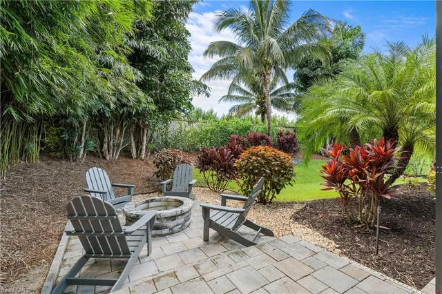 a view of house with backyard and sitting area