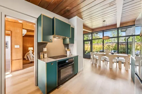 a spacious bedroom with a bed and a large window