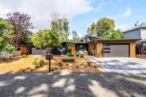 a front view of a house with garden
