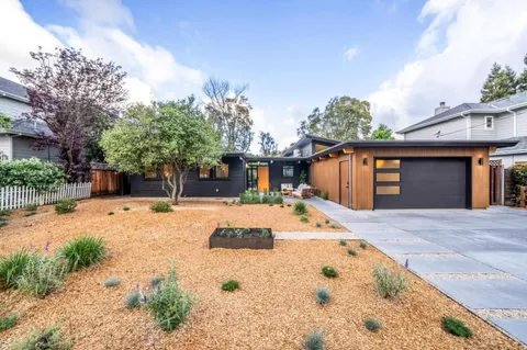 a living room with furniture and wooden floors