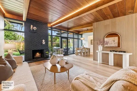 a living room with furniture a rug and kitchen view