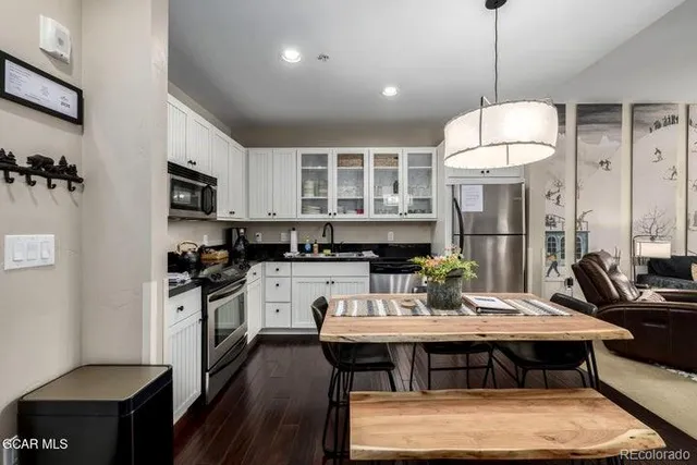 a kitchen with a dining table and chairs