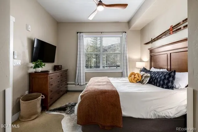 a bedroom with a bed and a flat screen tv