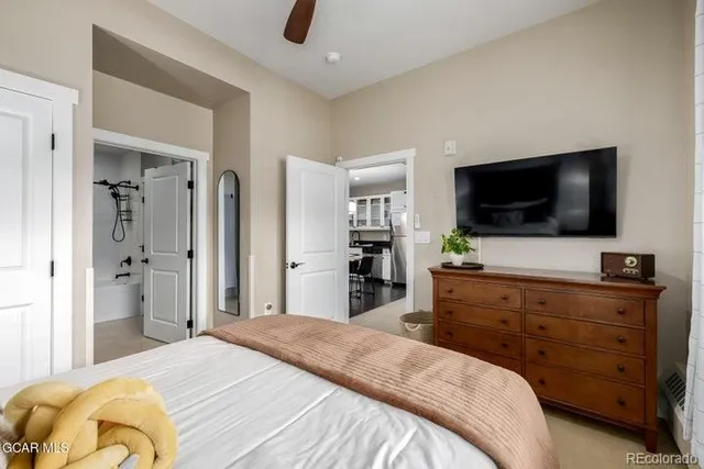 a bedroom with a bed and a flat screen tv in it