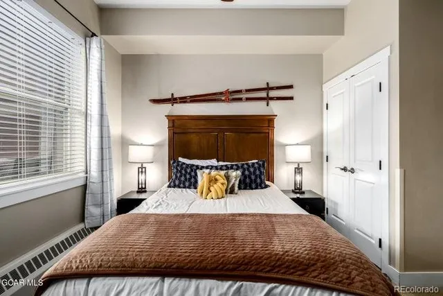 a bedroom with a bed and window