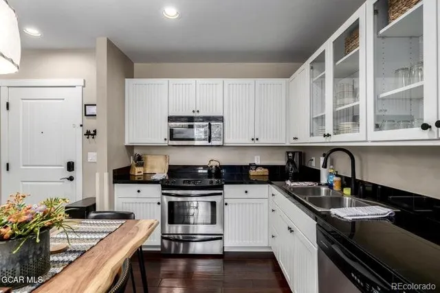 a kitchen with stainless steel appliances a sink stove and cabinets