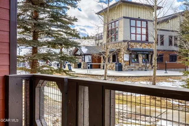 a view of a patio with table and chairs and wooden floor