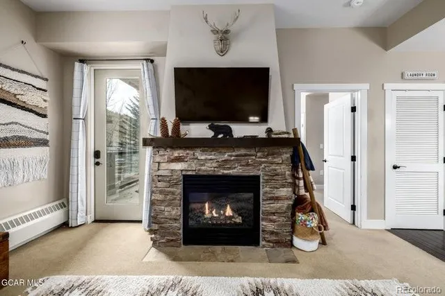 a living room with a fireplace and a flat screen tv