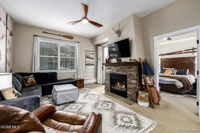 a living room with furniture a flat screen tv and a fireplace