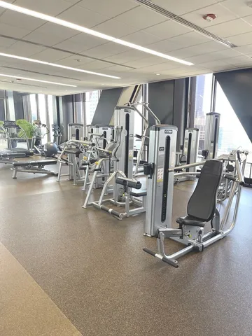 a storage room with stainless steel appliances and lots of furniture