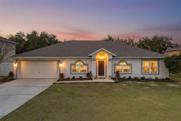 a front view of house with yard and outdoor seating