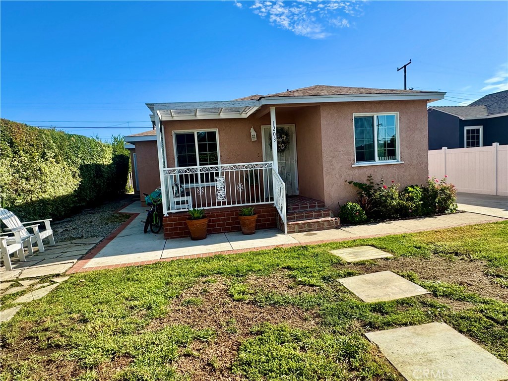 1203 West 134th Place Compton, CA 90222 - Photo 11 of 23 a front view of a house with garden