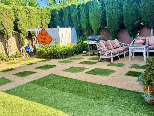 a view of a chair and table in the garden