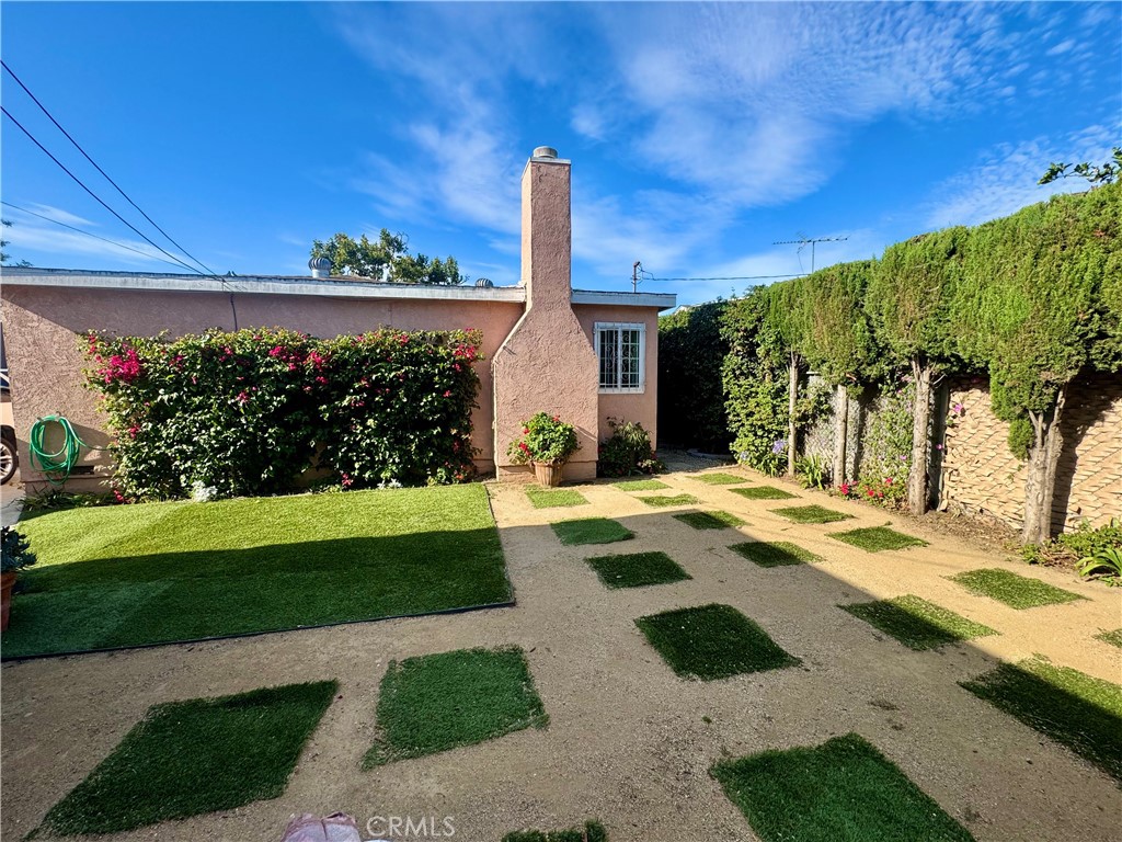1203 West 134th Place Compton, CA 90222 - Photo 16 of 23 a view of a house with backyard and a tree