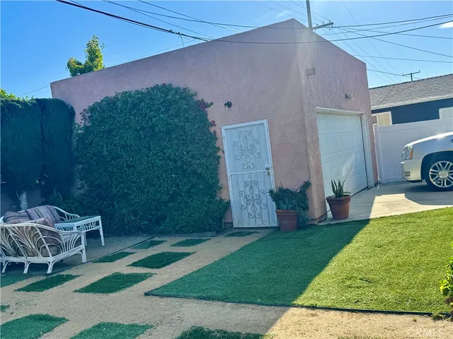 a backyard of a house with table and chairs