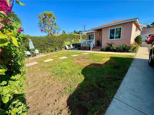 a front view of house with yard and outdoor seating