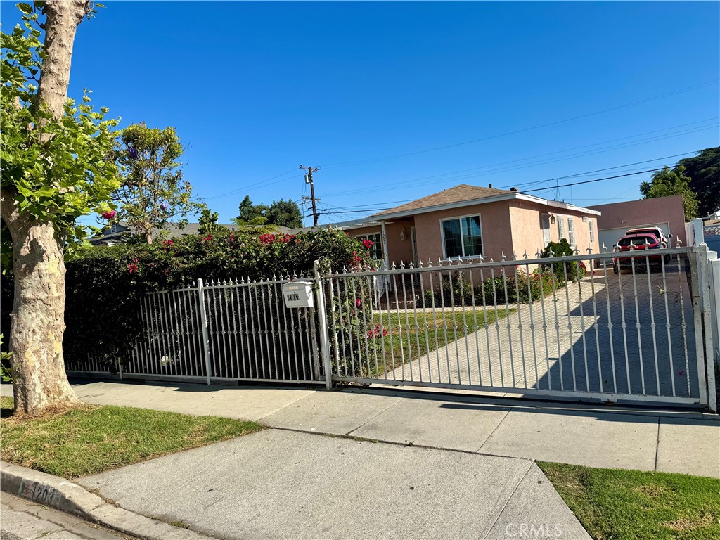 1203 West 134th Place Compton, CA 90222 - Photo 2 of 23 a view of a wrought iron fences in front of house