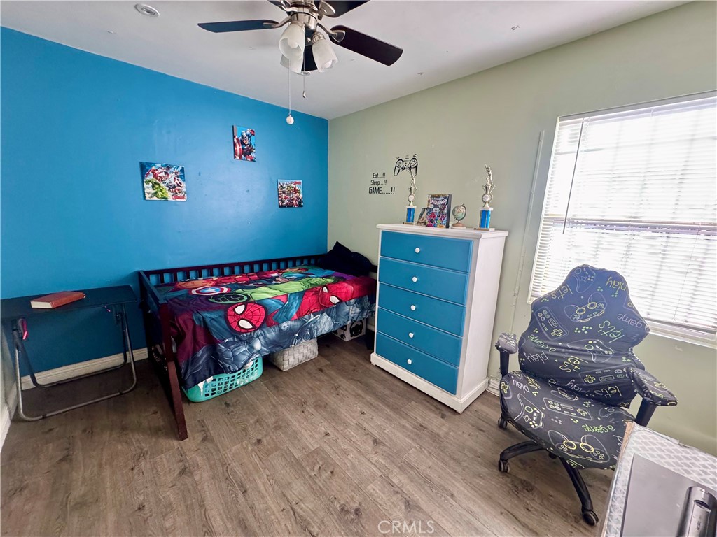 1203 West 134th Place Compton, CA 90222 - Photo 3 of 23 a bedroom with a bed and a chandelier