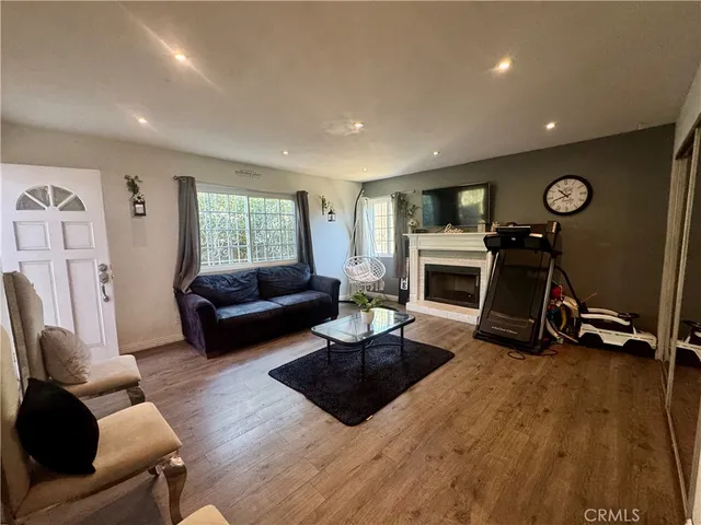 a living room with furniture a window and a fireplace