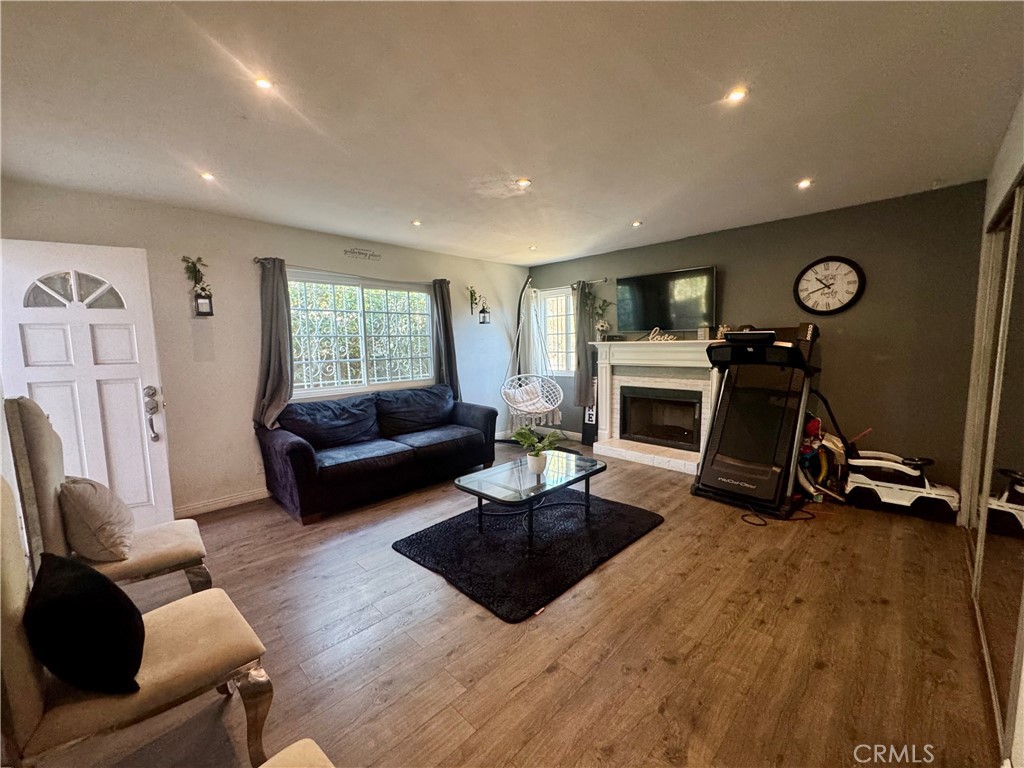 1203 West 134th Place Compton, CA 90222 - Photo 6 of 23 a living room with furniture a window and a fireplace