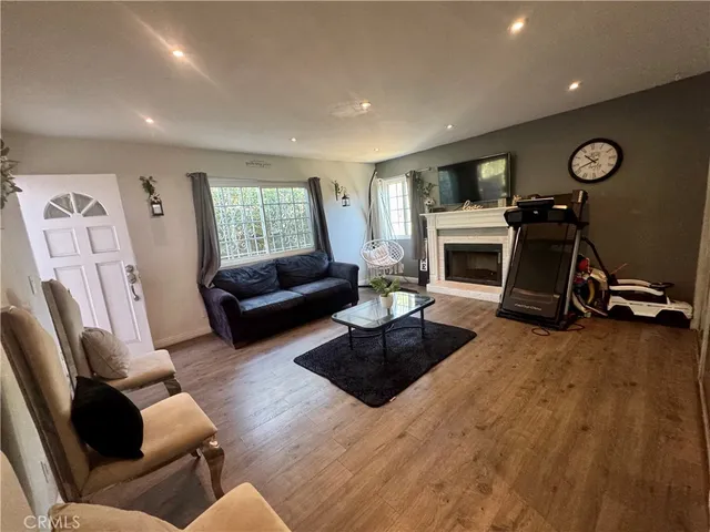 a living room with furniture a window and a fireplace