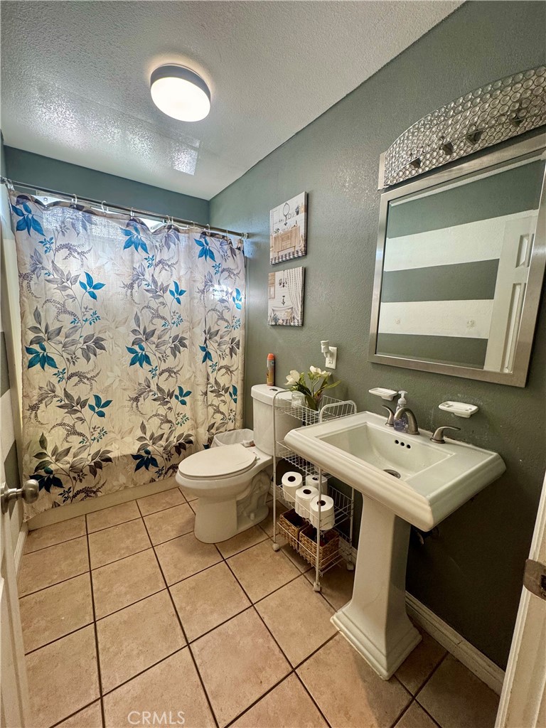 1203 West 134th Place Compton, CA 90222 - Photo 9 of 23 a bathroom with a sink toilet and shower