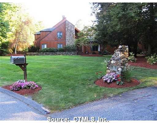 596 Cedar Grove Orange, CT 06477 - Photo 1 of 1 a front view of a house with a yard and garage