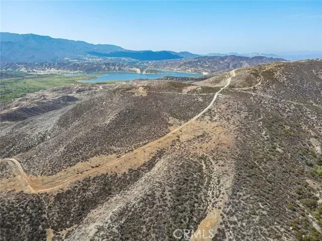 a view of a mountain with a field