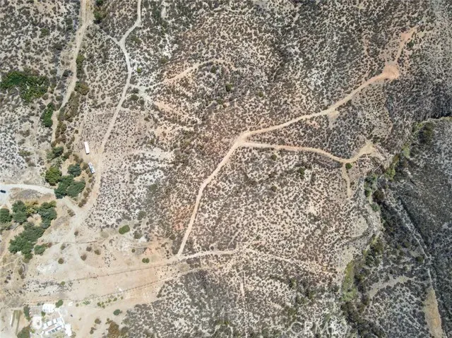 a view of a field with mountains in the background