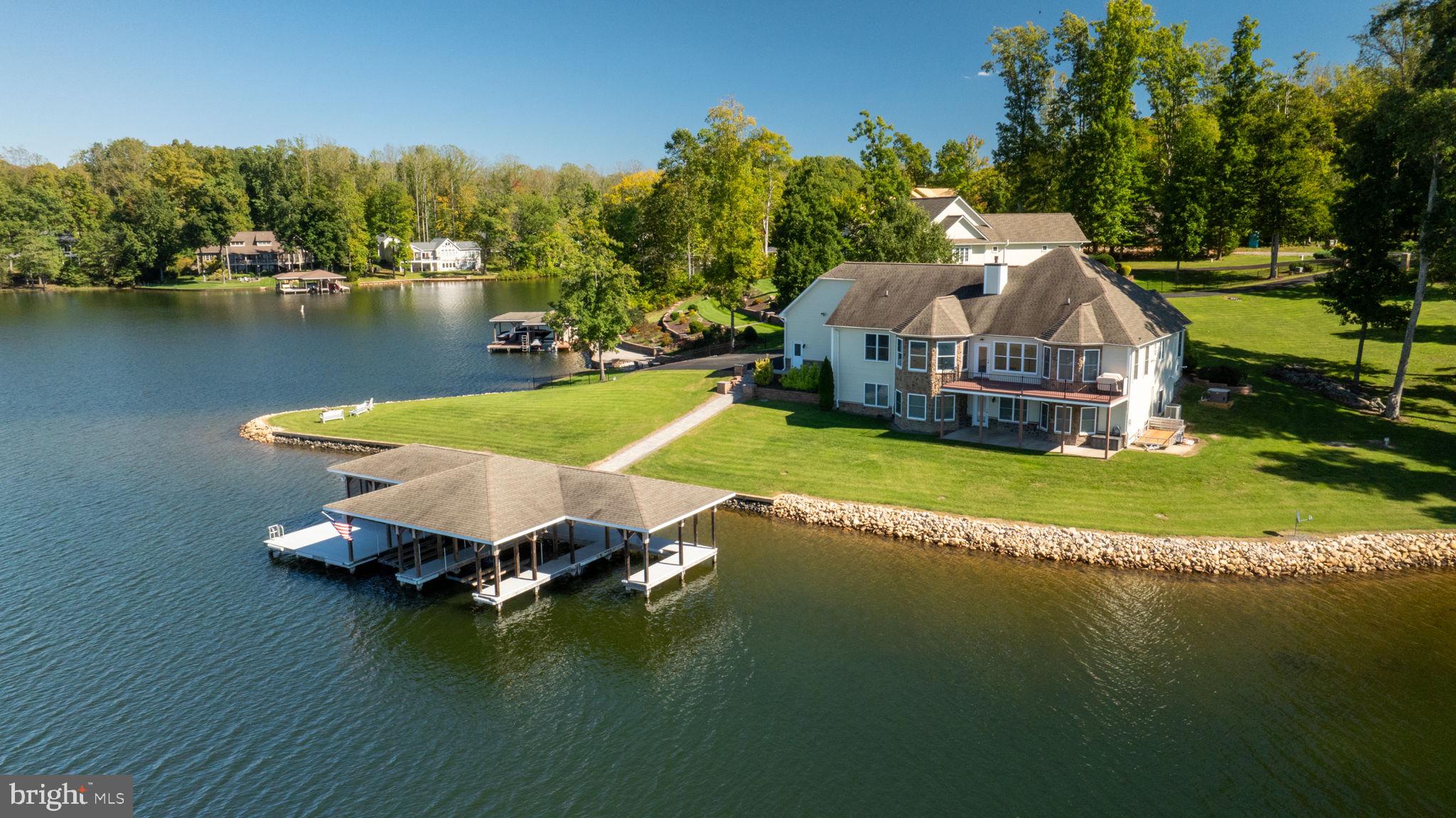 263 Lane Road Bumpass, VA 23024 - Photo 27 of 84 an aerial view of a house with swimming pool and lake view