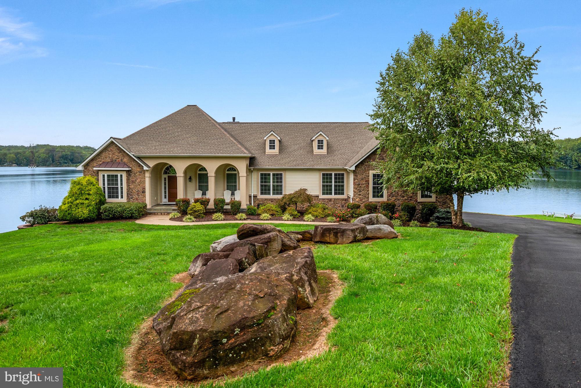 263 Lane Road Bumpass, VA 23024 - Photo 4 of 84 a front view of a house with a garden and outdoor seating