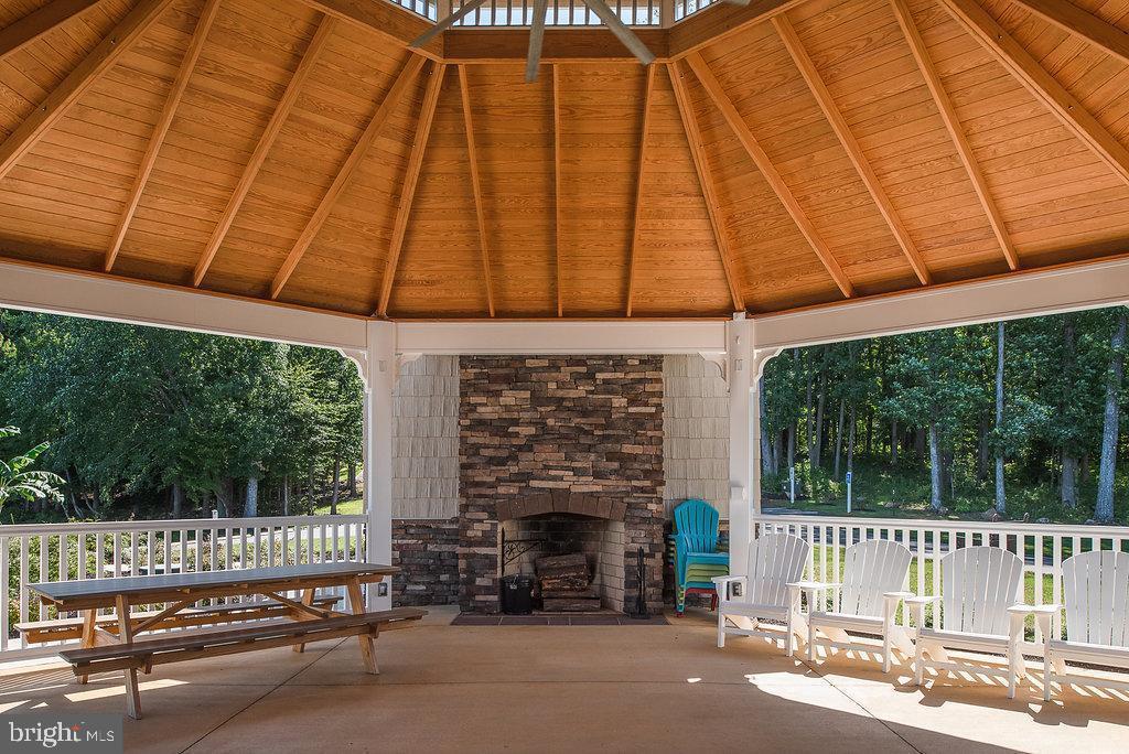 263 Lane Road Bumpass, VA 23024 - Photo 51 of 84 a view of a patio with a table and chairs under an umbrella