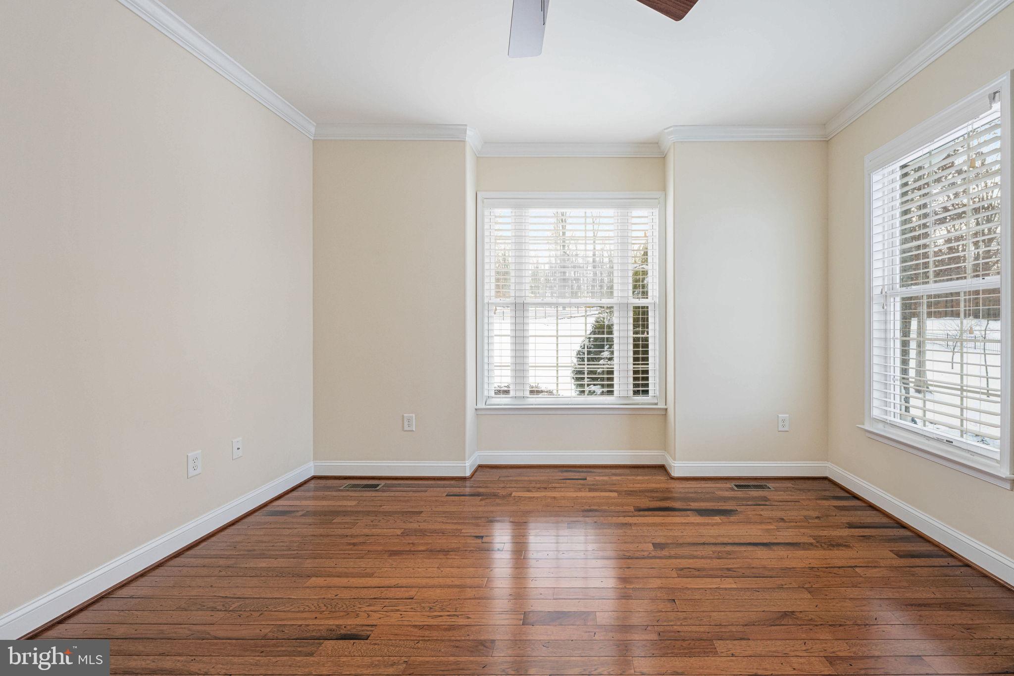 263 Lane Road Bumpass, VA 23024 - Photo 59 of 84 an empty room with wooden floor and windows