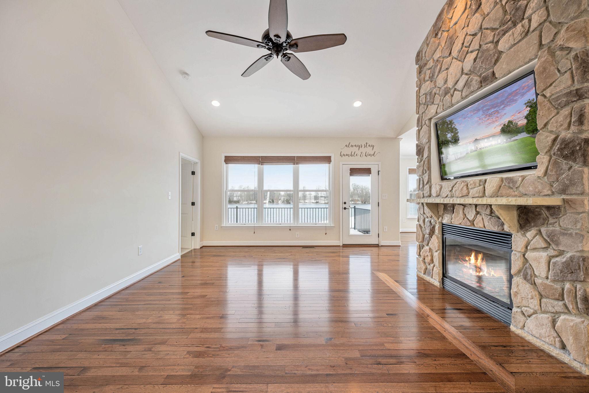 263 Lane Road Bumpass, VA 23024 - Photo 61 of 84 a view of an empty room with wooden floor and a fireplace
