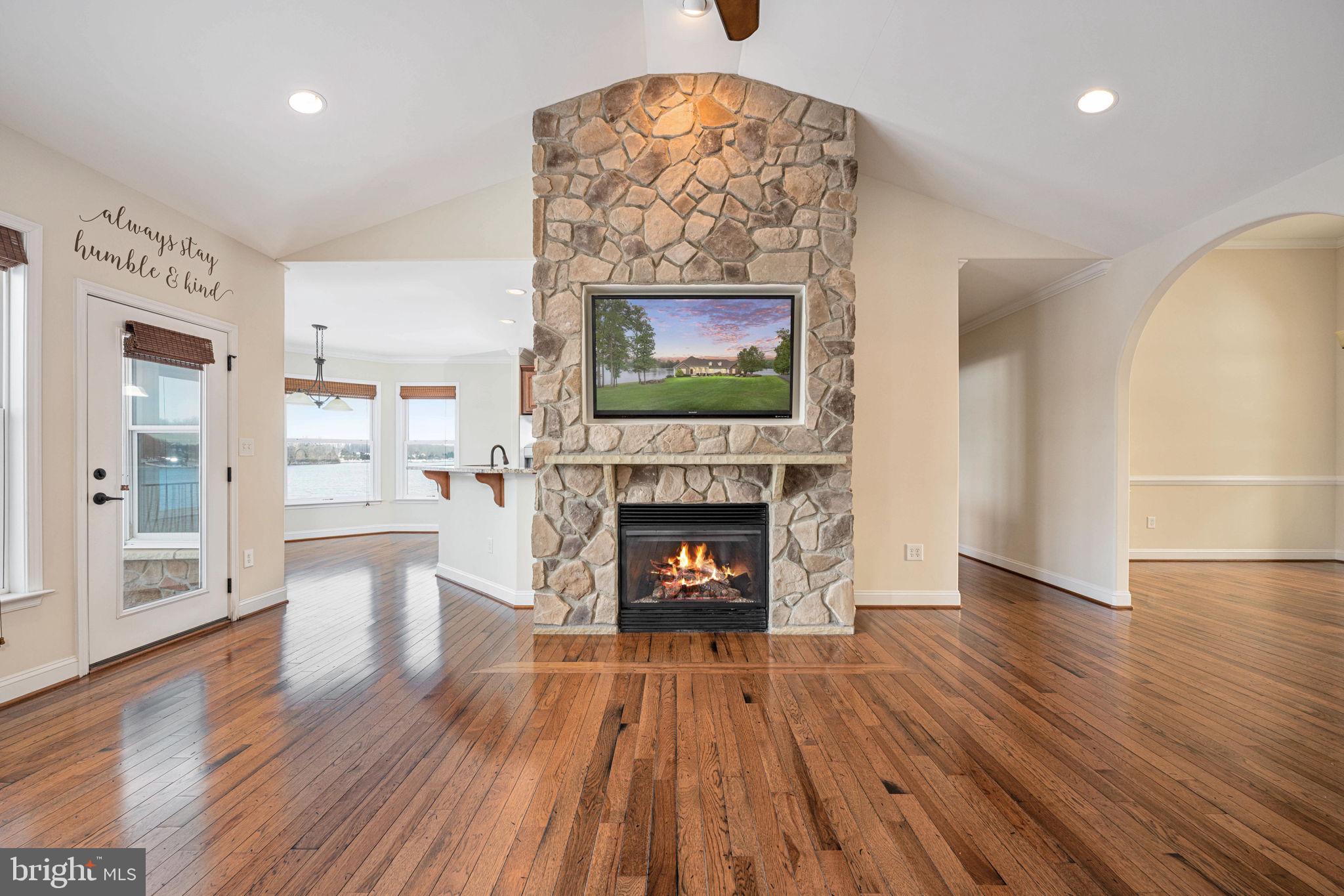 263 Lane Road Bumpass, VA 23024 - Photo 62 of 84 a living room with furniture a fireplace and a flat screen tv