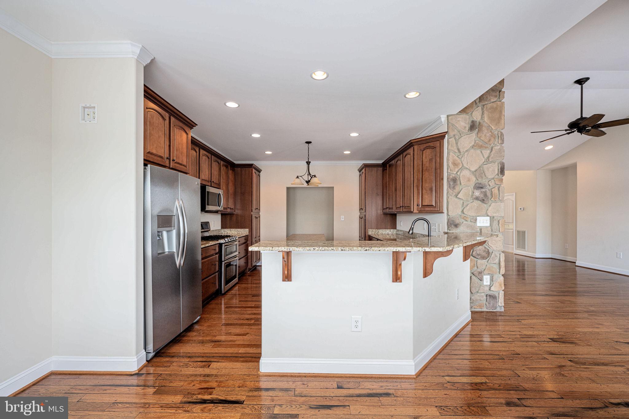 263 Lane Road Bumpass, VA 23024 - Photo 68 of 84 a kitchen with white cabinets and stainless steel appliances