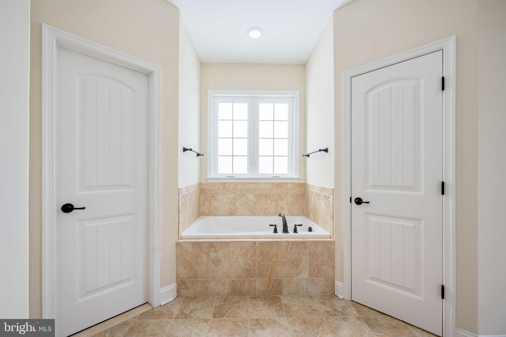263 Lane Road Bumpass, VA 23024 - Photo 71 of 84 a bathroom with a bathtub and a shower
