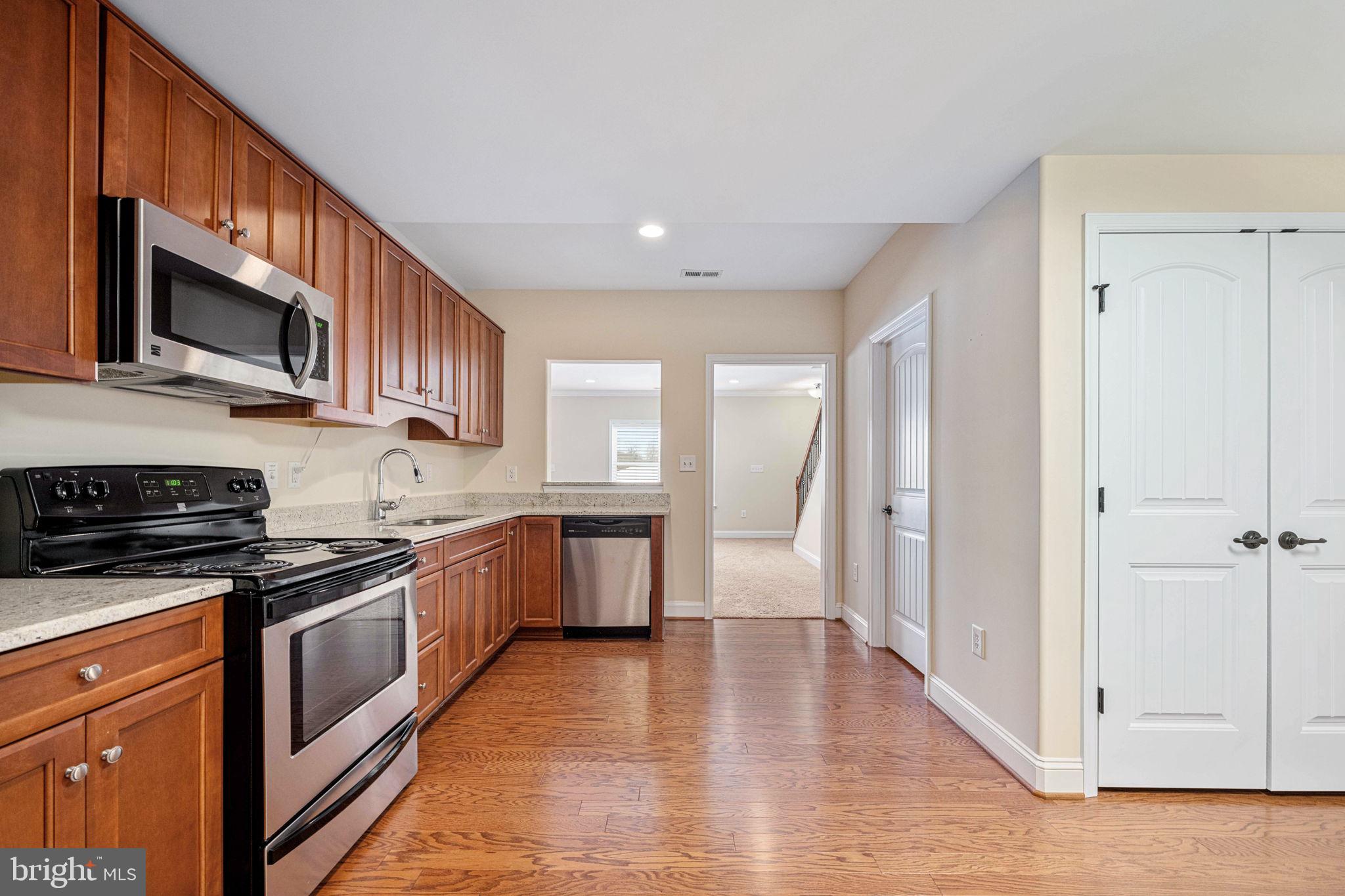 263 Lane Road Bumpass, VA 23024 - Photo 78 of 84 a kitchen with stainless steel appliances granite countertop a stove a sink and a microwave