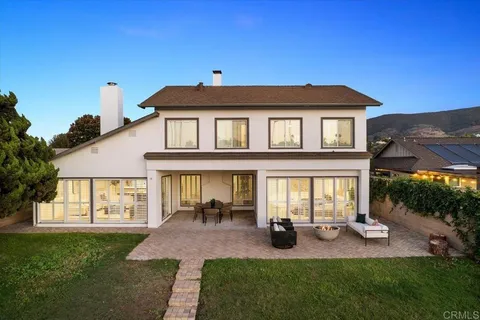 a front view of a house with swimming pool and porch
