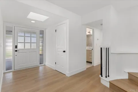 a bathroom with a granite countertop sink a toilet and a mirror