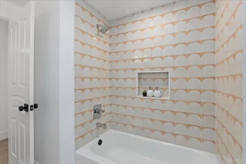 a bathroom with a mirror and a shower