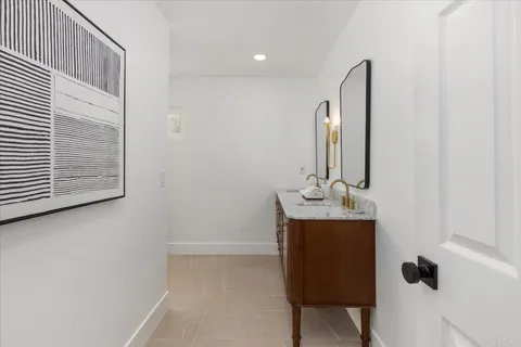 a bathroom with a double vanity sink and a mirror